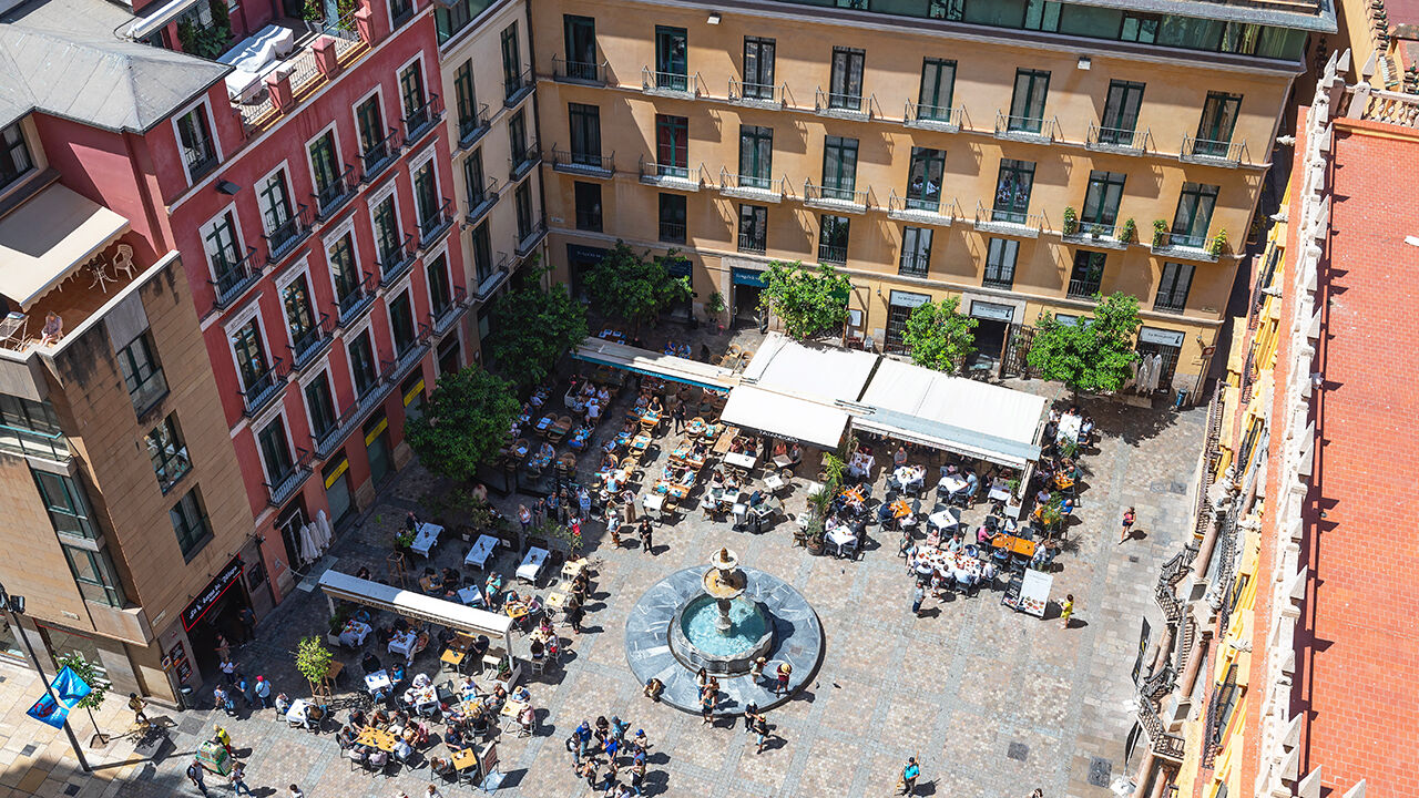 People dine in Bishop's Square, Malaga 