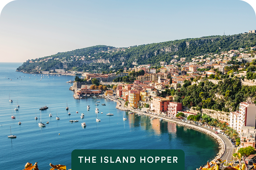 Turquoise bay and sailboats with The Island Hopper badge on Sardinia & Corsica — opens itinerary