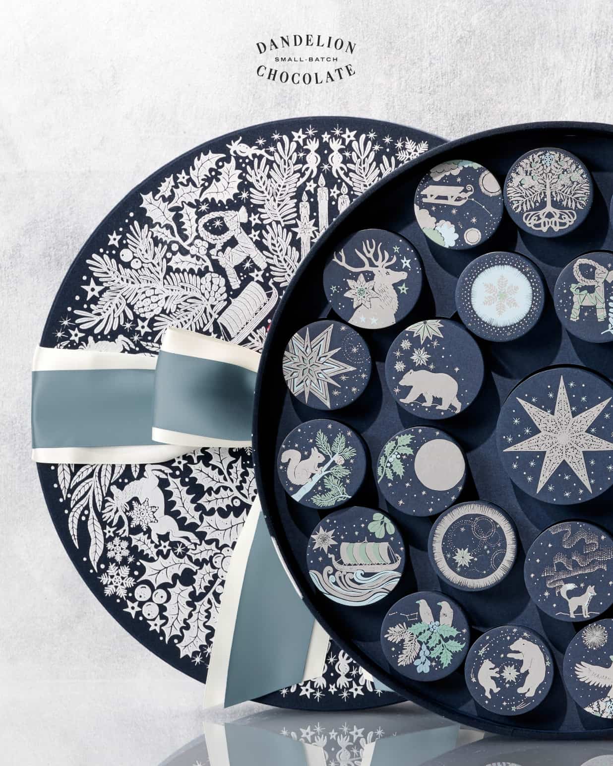 Our navy and silver Advent Calendar, opened to reveal Ornament boxes, whose designs are inspired by Nordic mythology. 