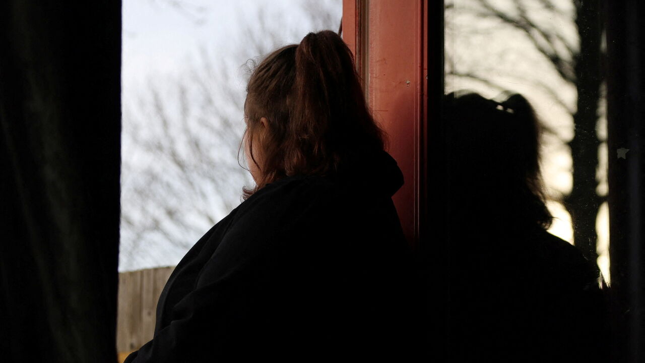 A woman poses at her home in England, Britain, January 8, 2025. She was 14 when she was sexually abused by a grooming gang in Rochdale.