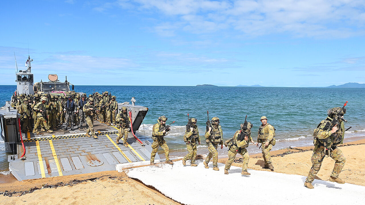 Soldiers are seen coming ashore as part of an amphibious landing rehearsal in Cowley Beach, Australia