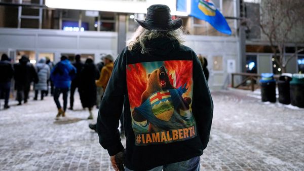 A male attendee with long grey hair and wearing a leather jacket with a Bear on the back arrive for the Alberta Independence Town Hall event in Calgary, Alberta, Canada.