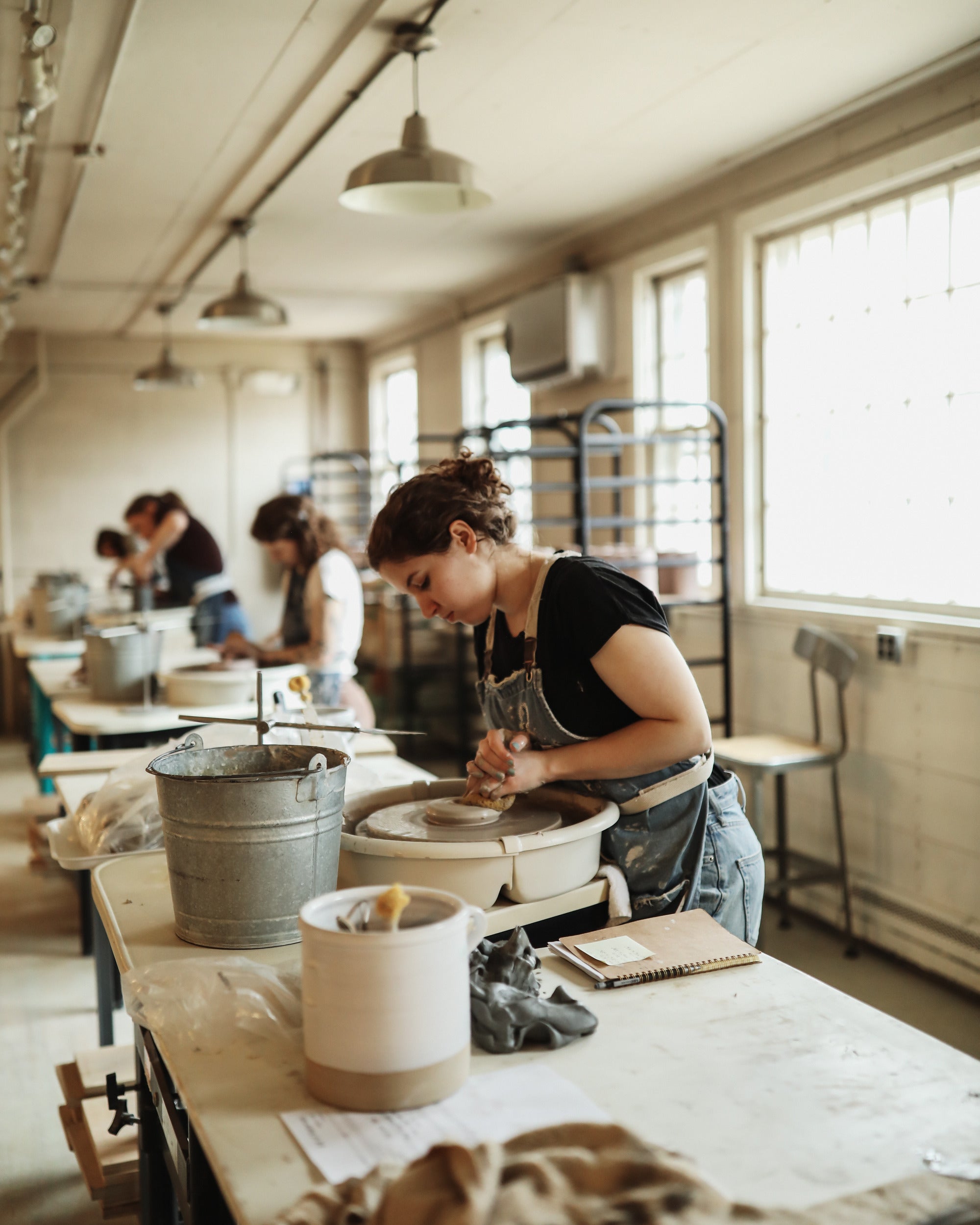 A potter at the wheel in the studio