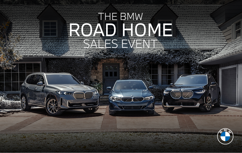 Three BMWs parked outside of a house covered in snow for The BMW Road Home Sales Event.