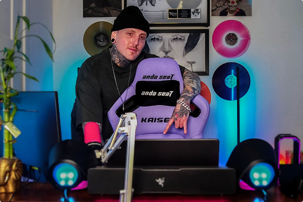 A man leaning on a gaming chair
