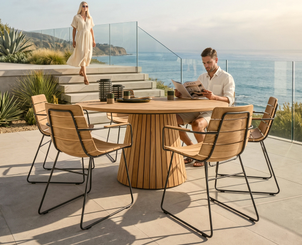 Image of a couple relaxing beside a round dining set on an oceanfront patio