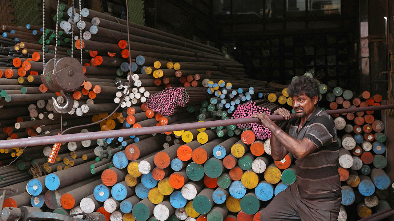 A man works inside a steel warehouse in Mumbai