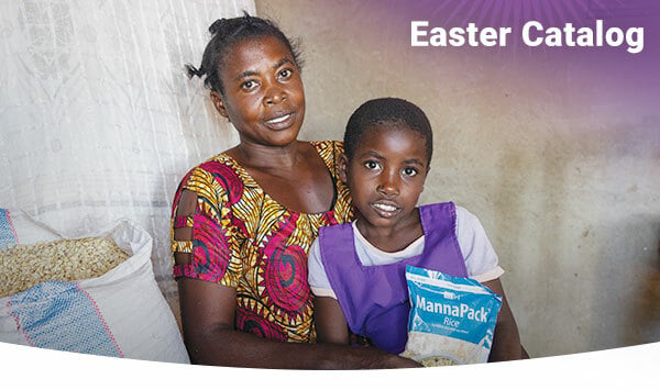 A woman and her daughter holding a pack of Vitafood.