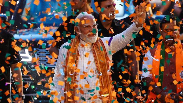 India's Prime Minister Narendra Modi greets his supporters as he arrives at Bharatiya Janata Party (BJP) headquarters