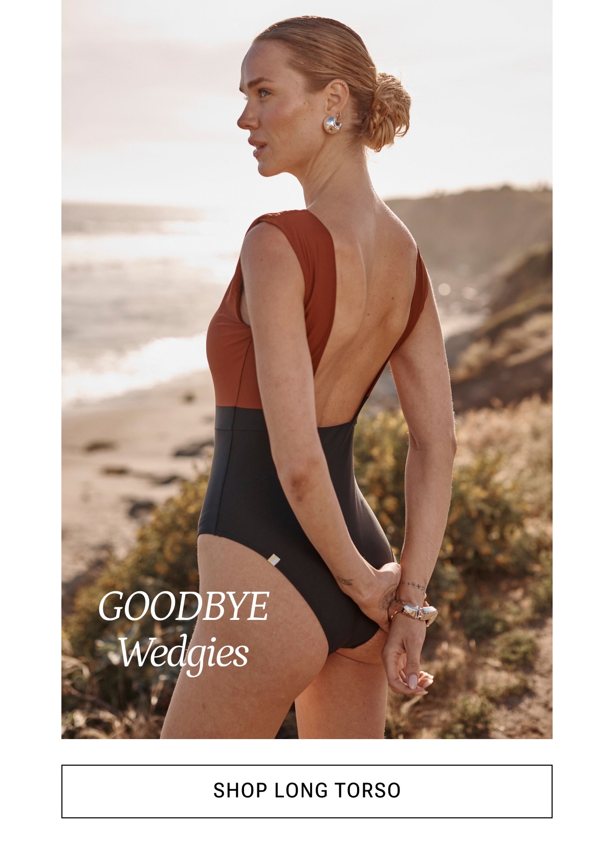 Model in black and brown one piece swimsuit
