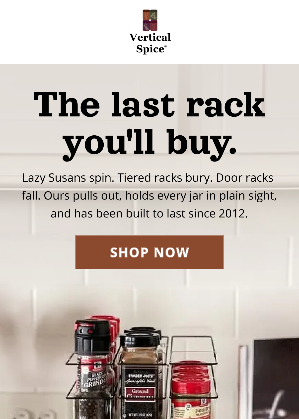 Pull-out spice rack drawer fully extended in modern kitchen, showing all spice jars clearly organized and visible