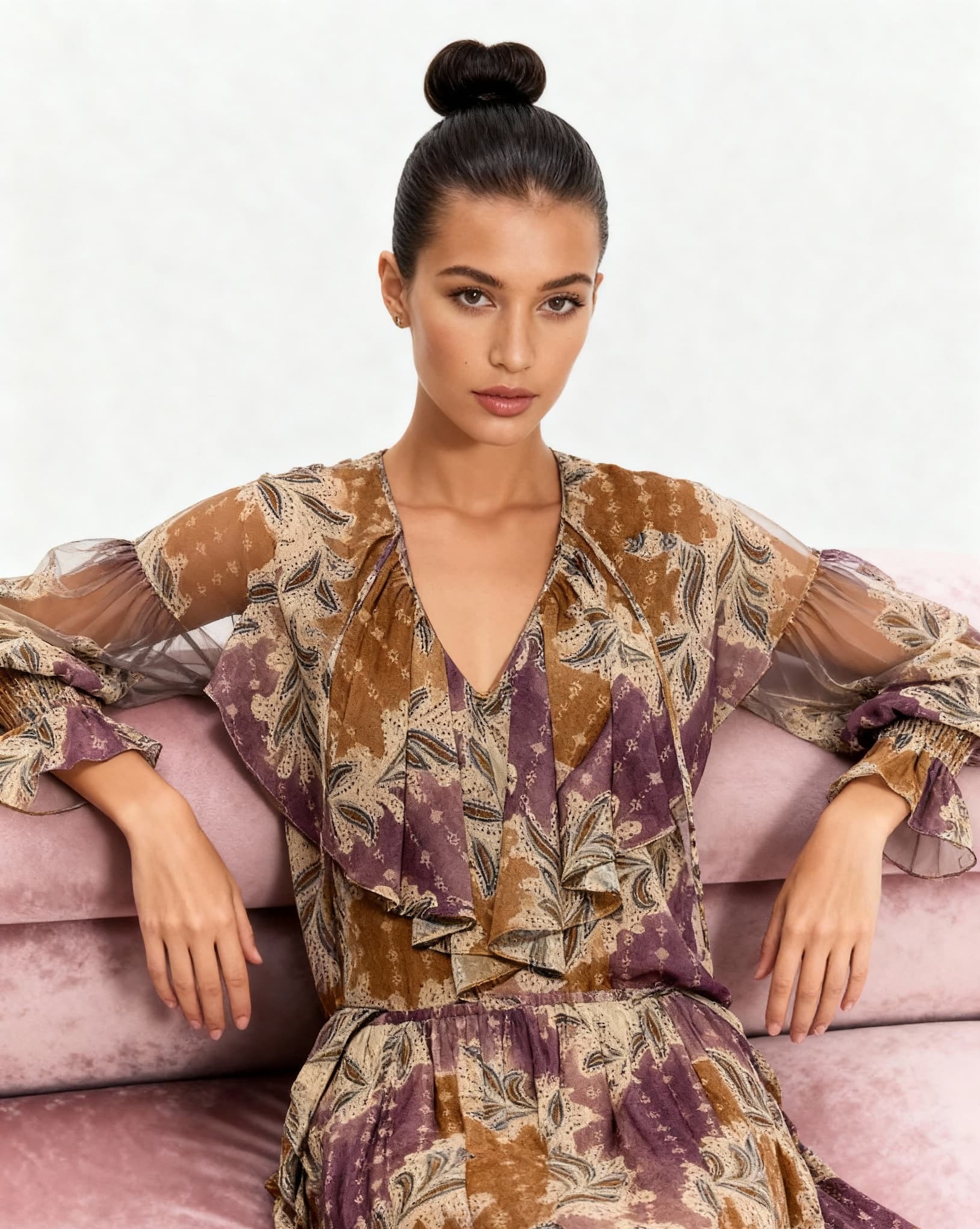 woman on couch wearing flowing printed top and skirt