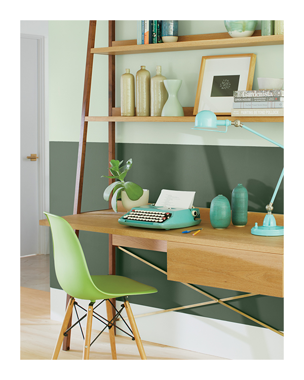 Bedroom with bookshelf and bed frame in dark green, mid-toned green ceiling, and window with white trim.