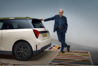 Paul Smith with arm against MINI and smiling