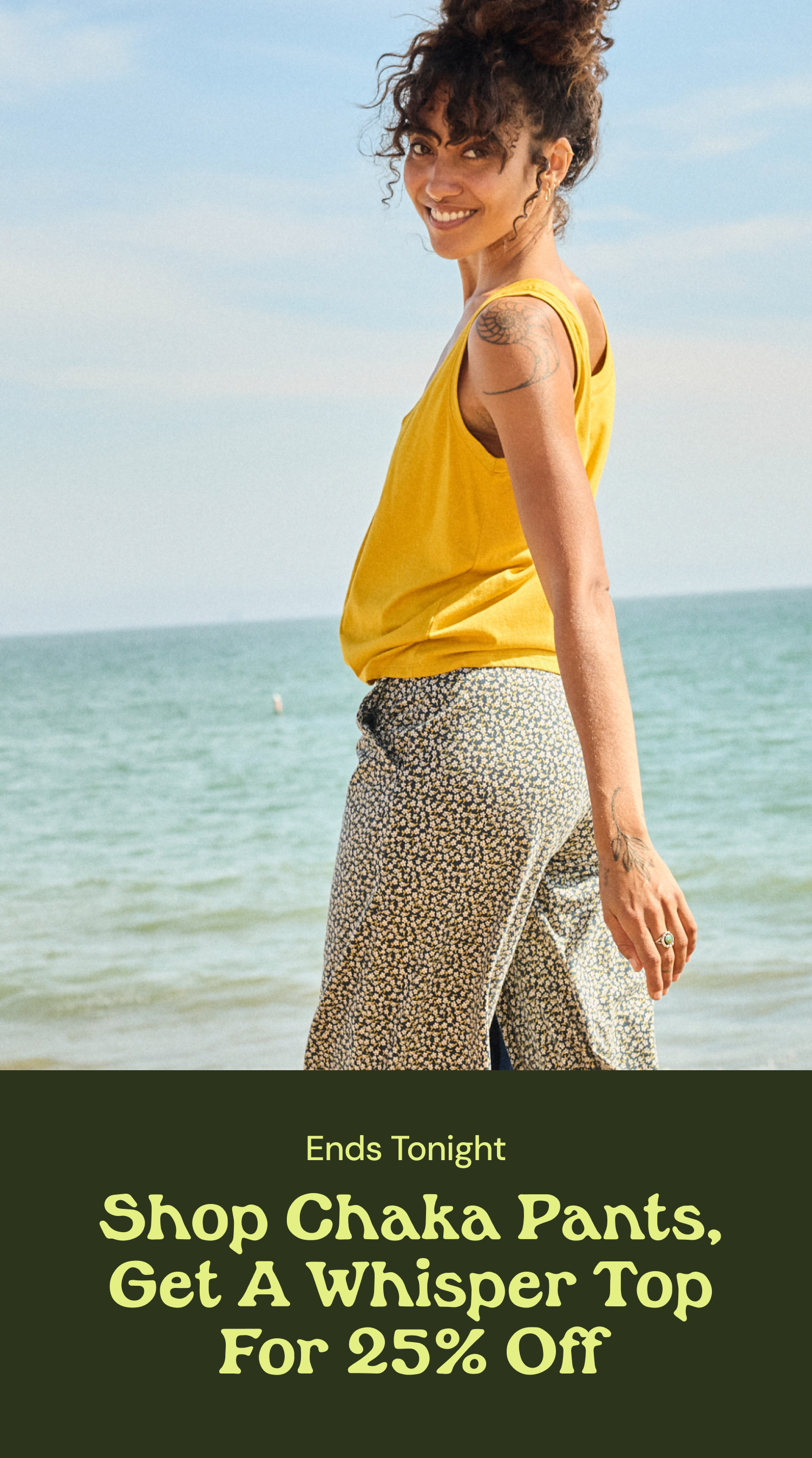 an image of a woman walking on the beach with a yellow top