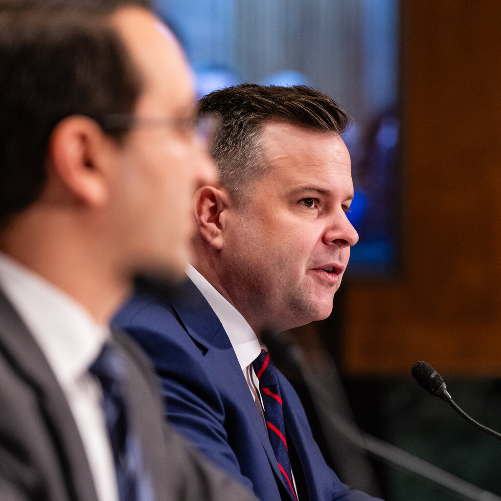 Bill Pulte speaks at a microphone during a hearing.