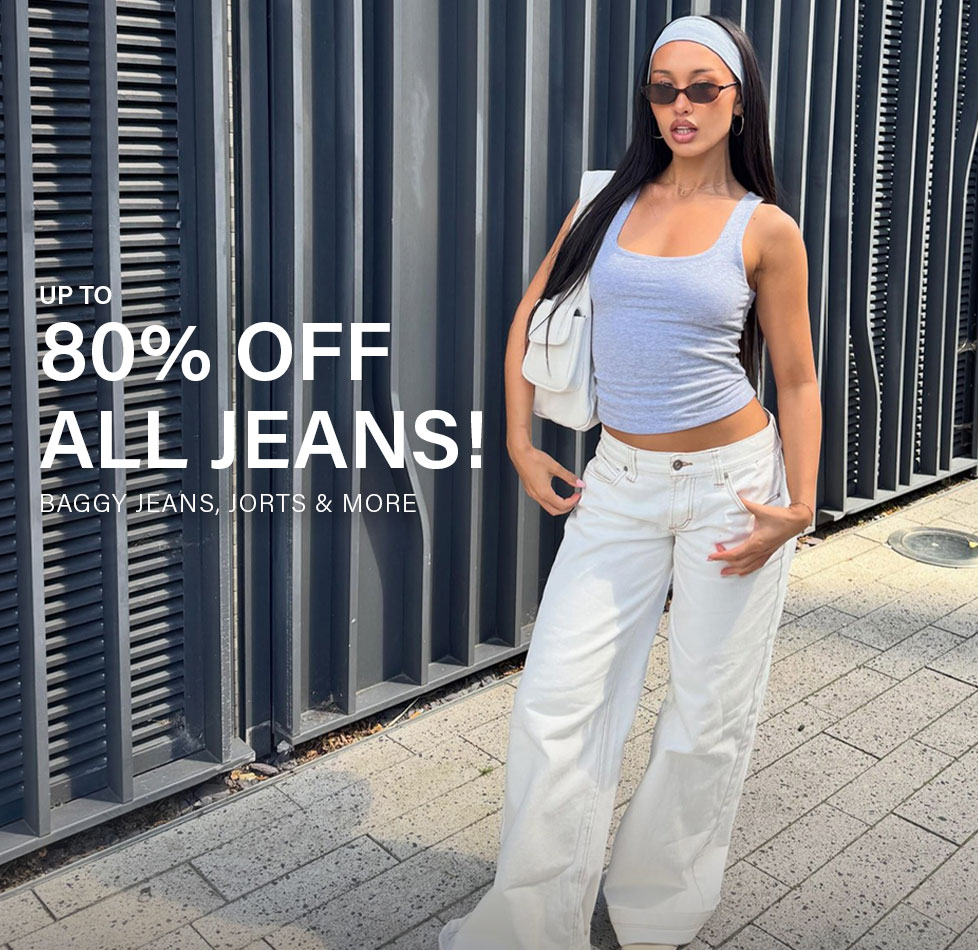 Get 90% off all jeans! Woman in white baggy jeans, grey tank. Shop baggy jeans, jorts, & other denim styles on sale.