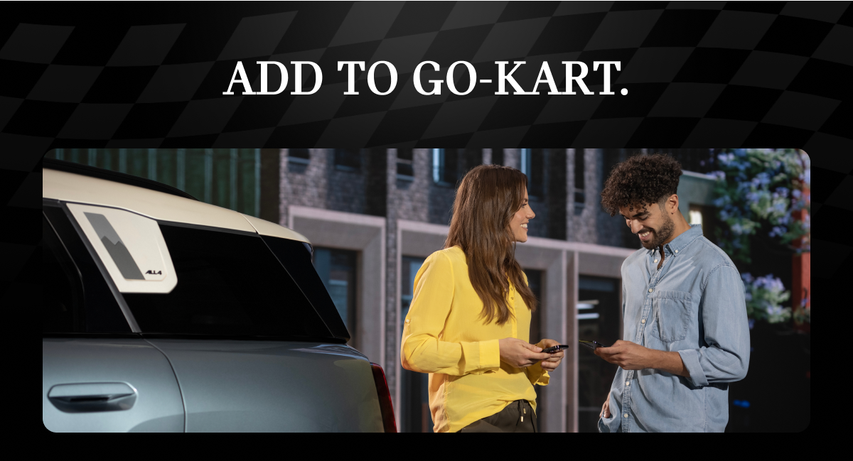 Two people talking next to a MINI