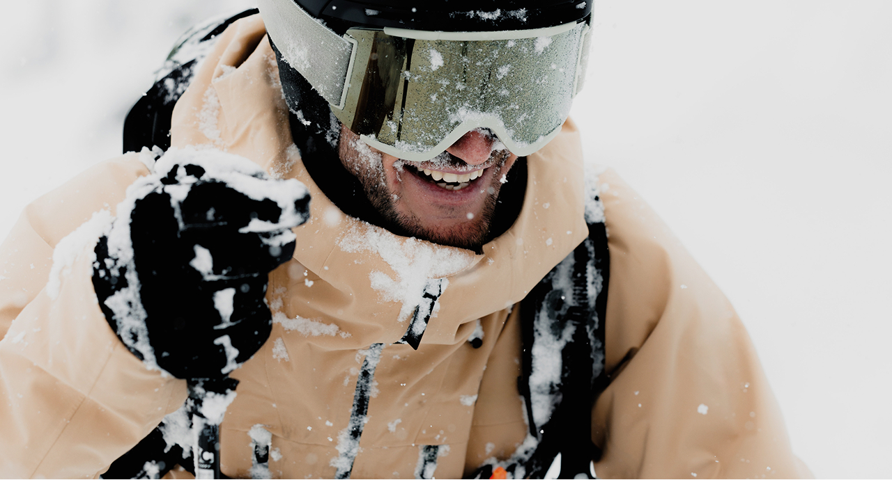 Man in the snow in a tan jacket
