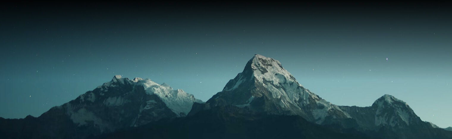 Snow covered mountains at night.