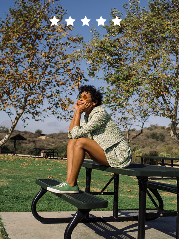 Women sitting in a park, with cactus green sneakers