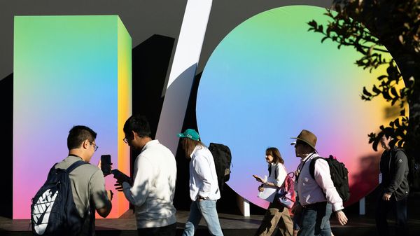  Attendees walk past an I/O sign displayed at Google I/O.