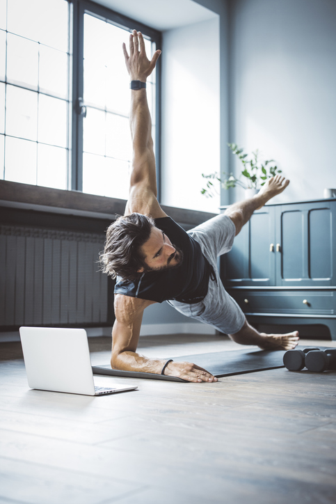 man
performing core strength exercises on a mat