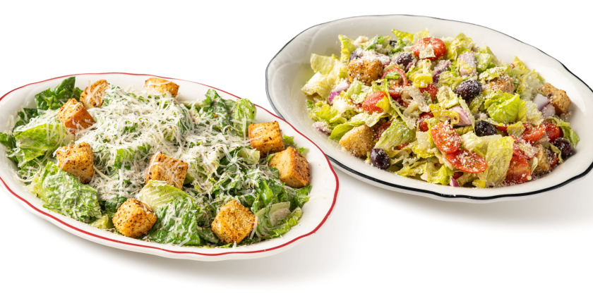 Two plates of Maggiano’s Salads, including Chef’s Signature Caesar, and Maggiano’s Salad