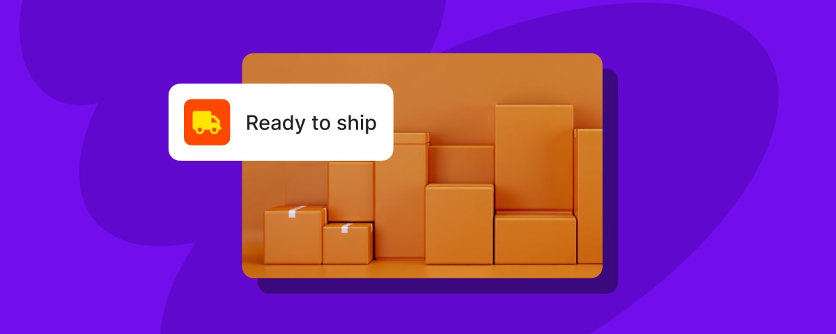  A 3D rendering with a purple background. In the foreground, a brown platform holds a variety of brown cardboard boxes of different sizes, arranged to look like a city skyline. A white pop-up notification with rounded corners floats above the boxes. It has an orange square icon with a yellow delivery truck on the left and the black text "Ready to ship" on the right.