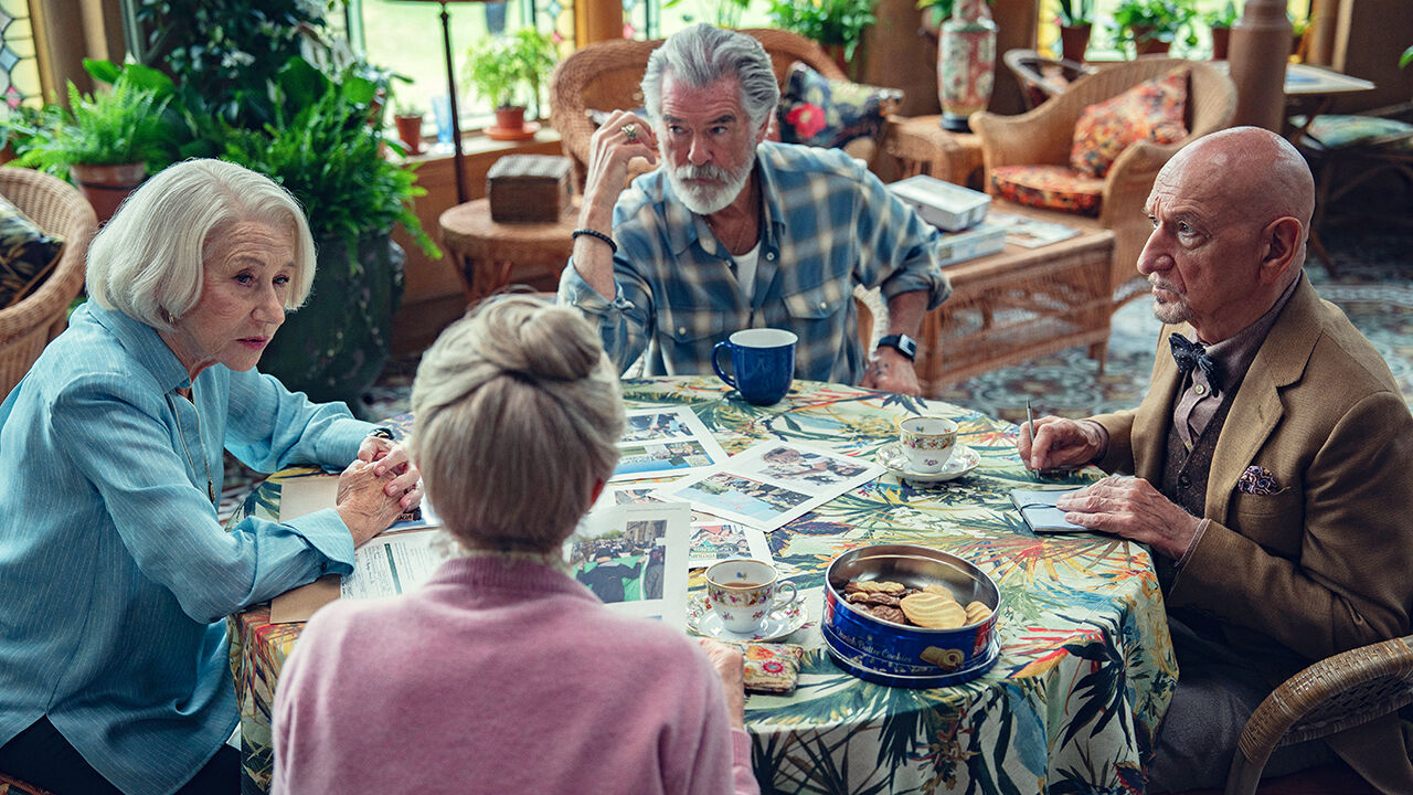 Characters around a table in The Thursday Murder Club
