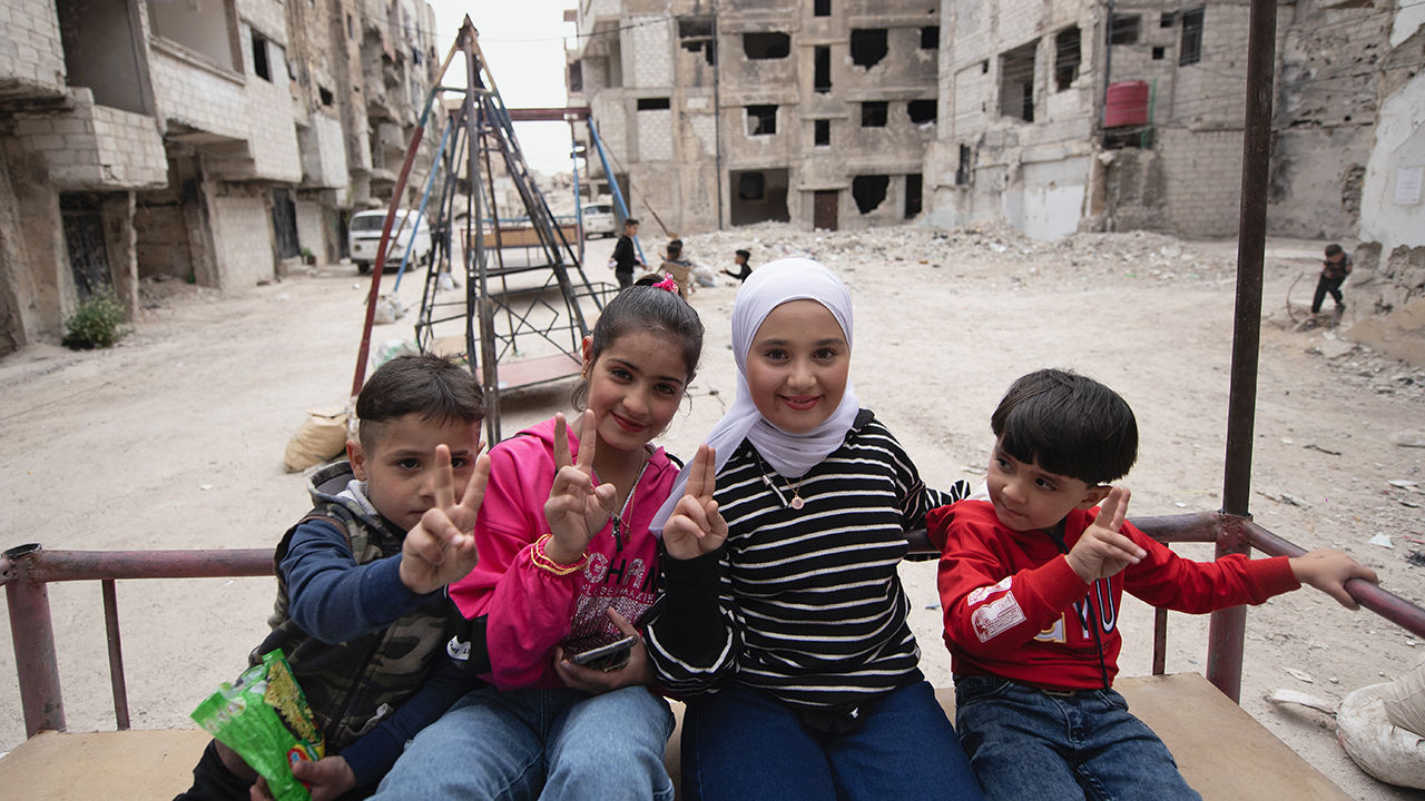 Children celebrate Eid-al-Fitr at an amusement park set up in the Yarmouk Refugee Camp, Damascus, Syria, April 1st 2025