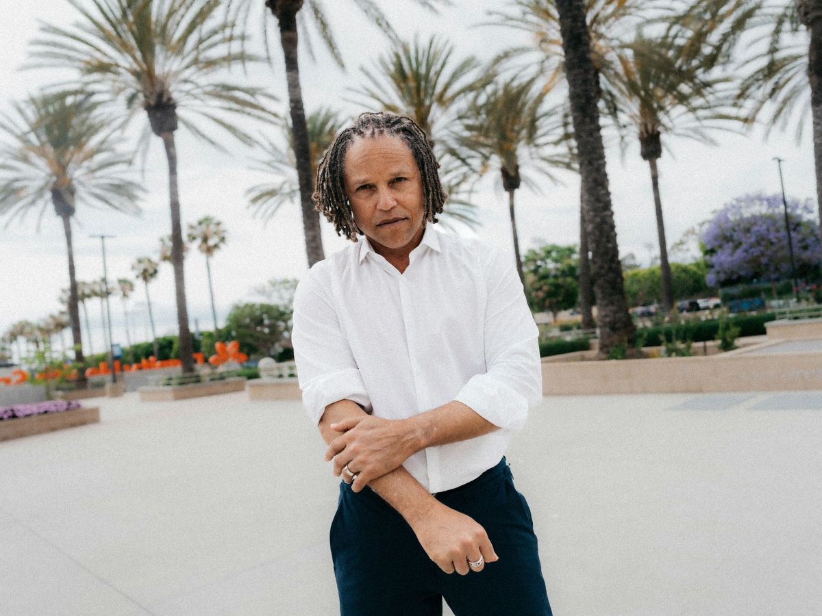 Cobi Jones in a white button-up shirt and slacks standing on the grounds of Dignity Health Sports Park.