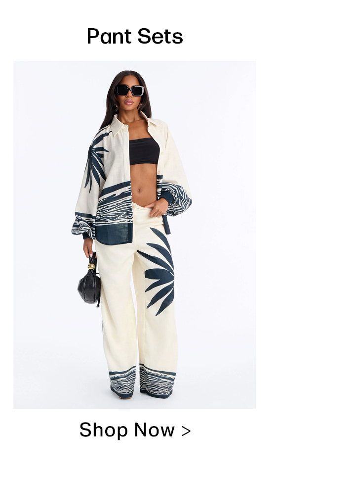 Stylish woman in cream & navy leaf and wave print pant set with black bandeau & sunglasses. Shop new women's matching sets.
