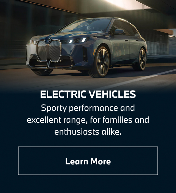 BMW iX driving down the road. Learn more.