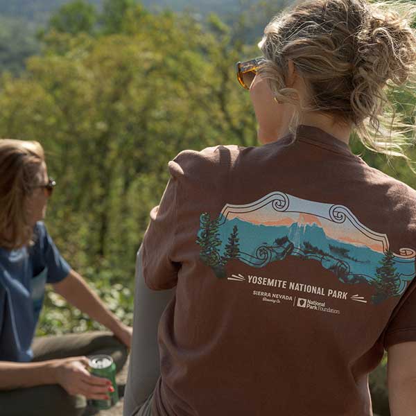 A woman wearing a t-shirt from the Sierra Nevada x National Park Foundation Limited-Edition Collection
