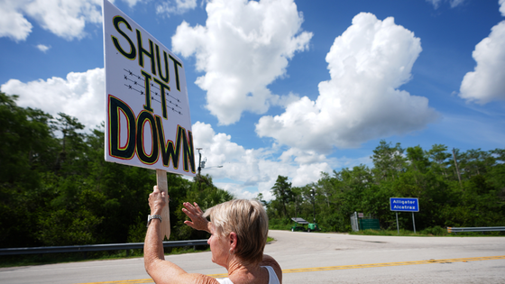 A protester holds a sign.
