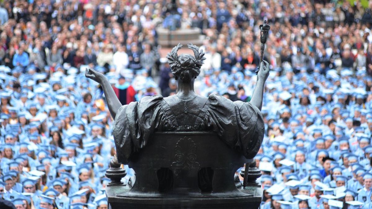 Rear view of Alma Mater with graduates in the background
