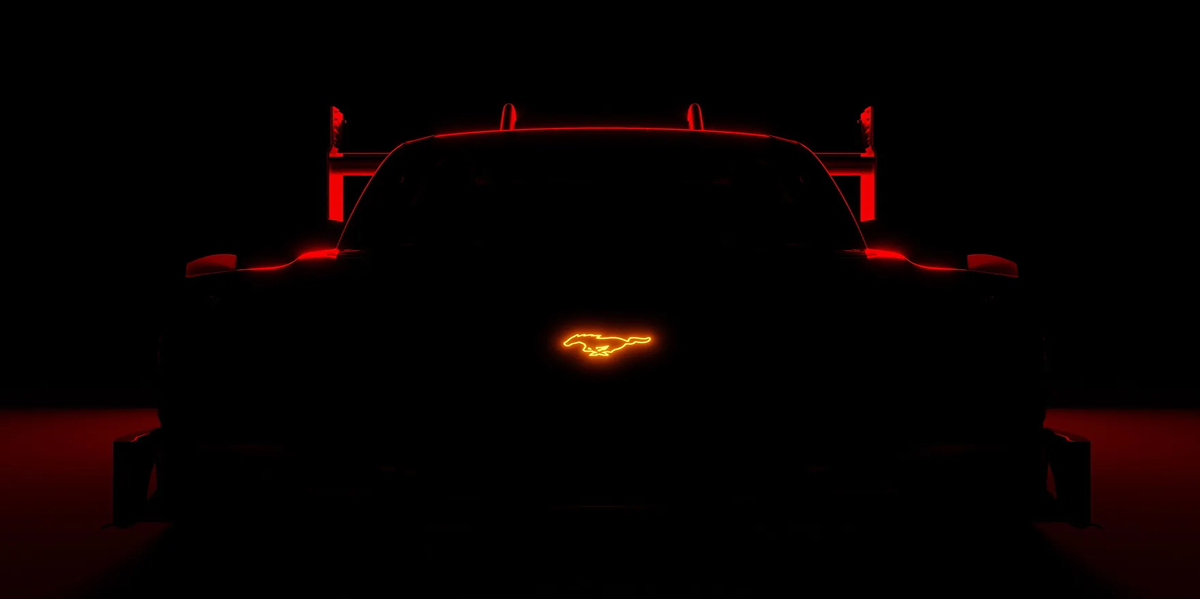 A dimly lit Mustang&reg; car with the Ford front logo glowing