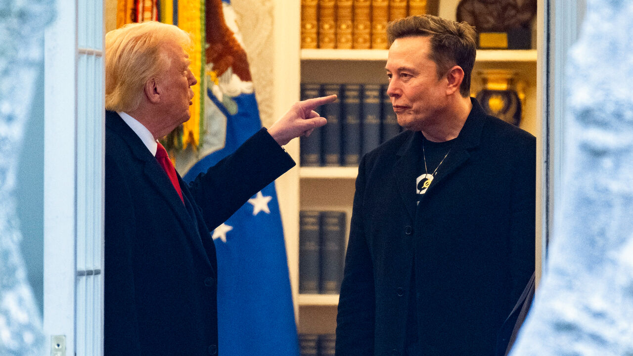 US President Donald Trump points a finger at Elon Musk whilst talking to him.