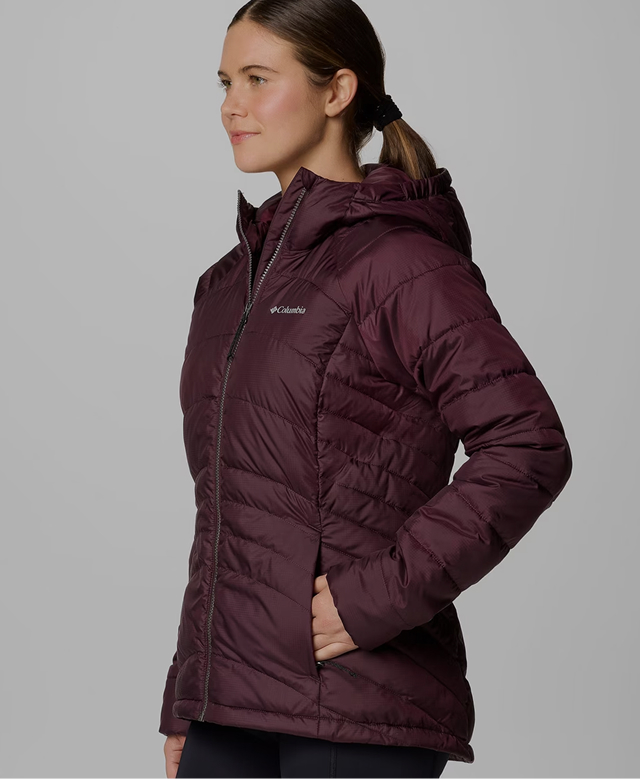 A woman wearing a white puffer jacket.