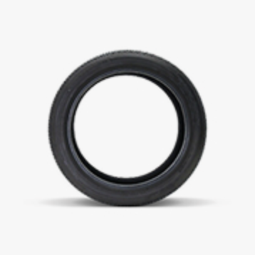 A black tubeless tire sits on a light grey background.