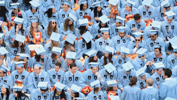 A sea of graduates in Columbia blue caps and gowns