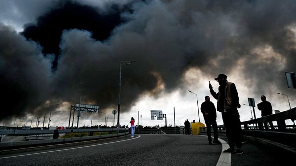 Black smoke rises from the refinery where a fire broke out following a strike as firefighting efforts continue in Moscow, Russia.
