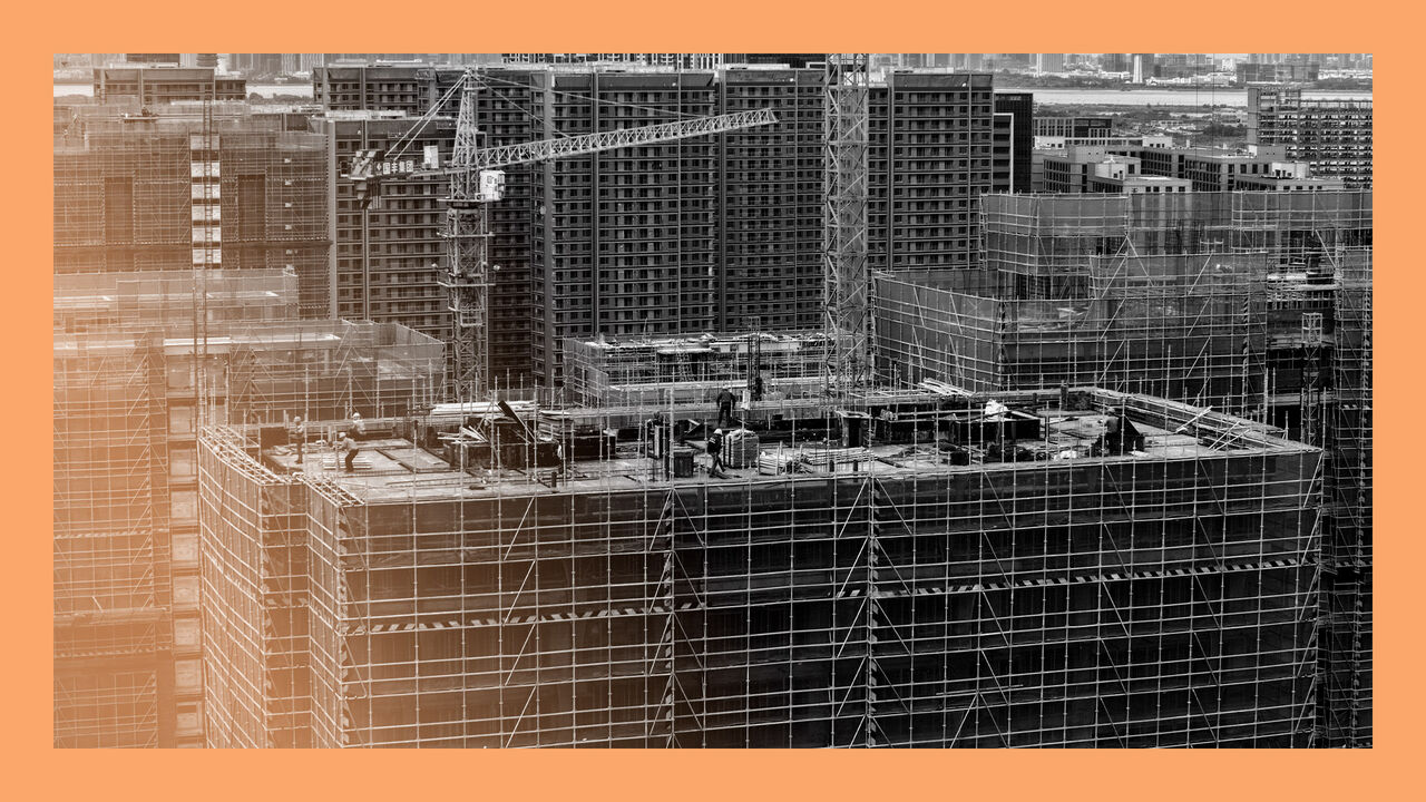 A new residential complex under construction with workers and cranes pictured, in Hangzhou City, Zhejiang Province, China.