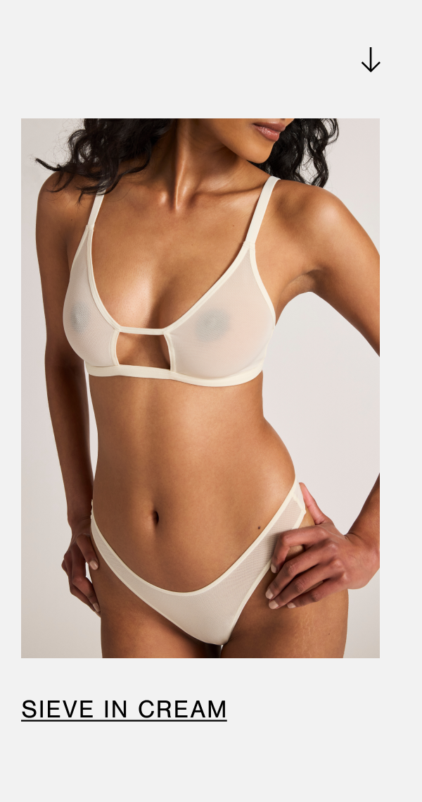 Model is wearing the Sieve Cutout Bra and Dipped Thong in Cream.