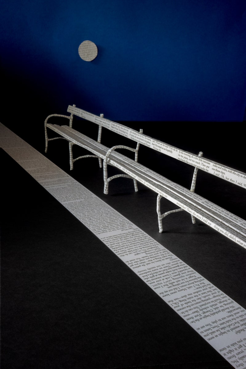 Park bench made out of magazine pages.