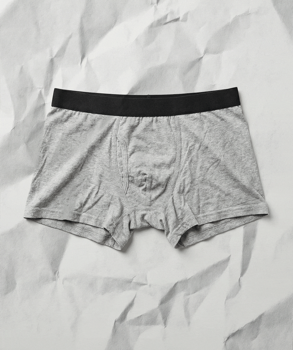 an image of a pair of underwear is laying on a crumpled sheet