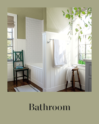 A green painted bathroom with white beadboard.