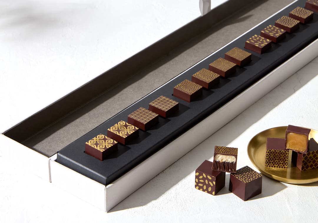 The two-foot-long Origin Bonbon Collection, opened to reveal a row of confections.