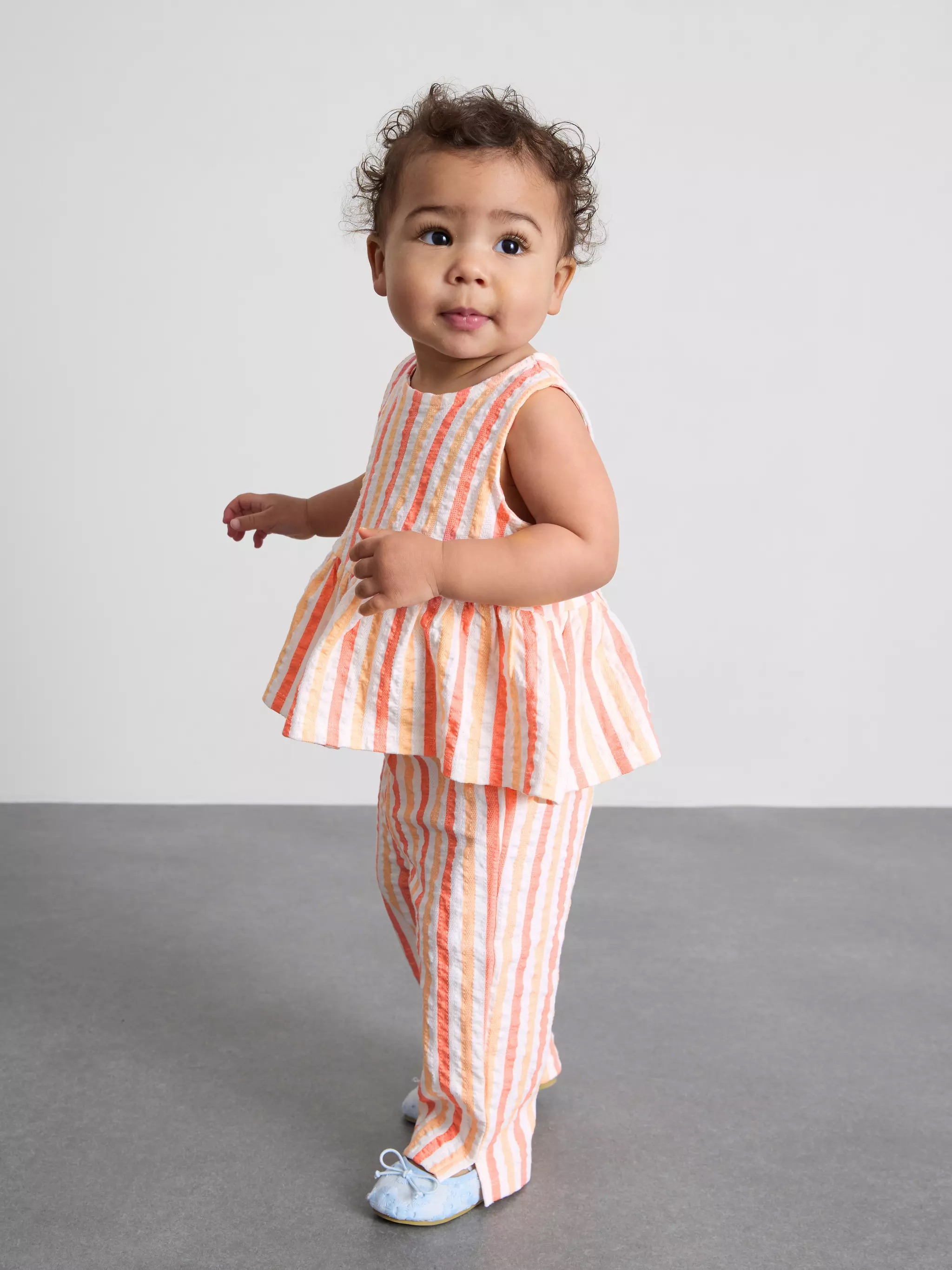 Baby girl wearing a Stripe Peplum Top and Pants Set